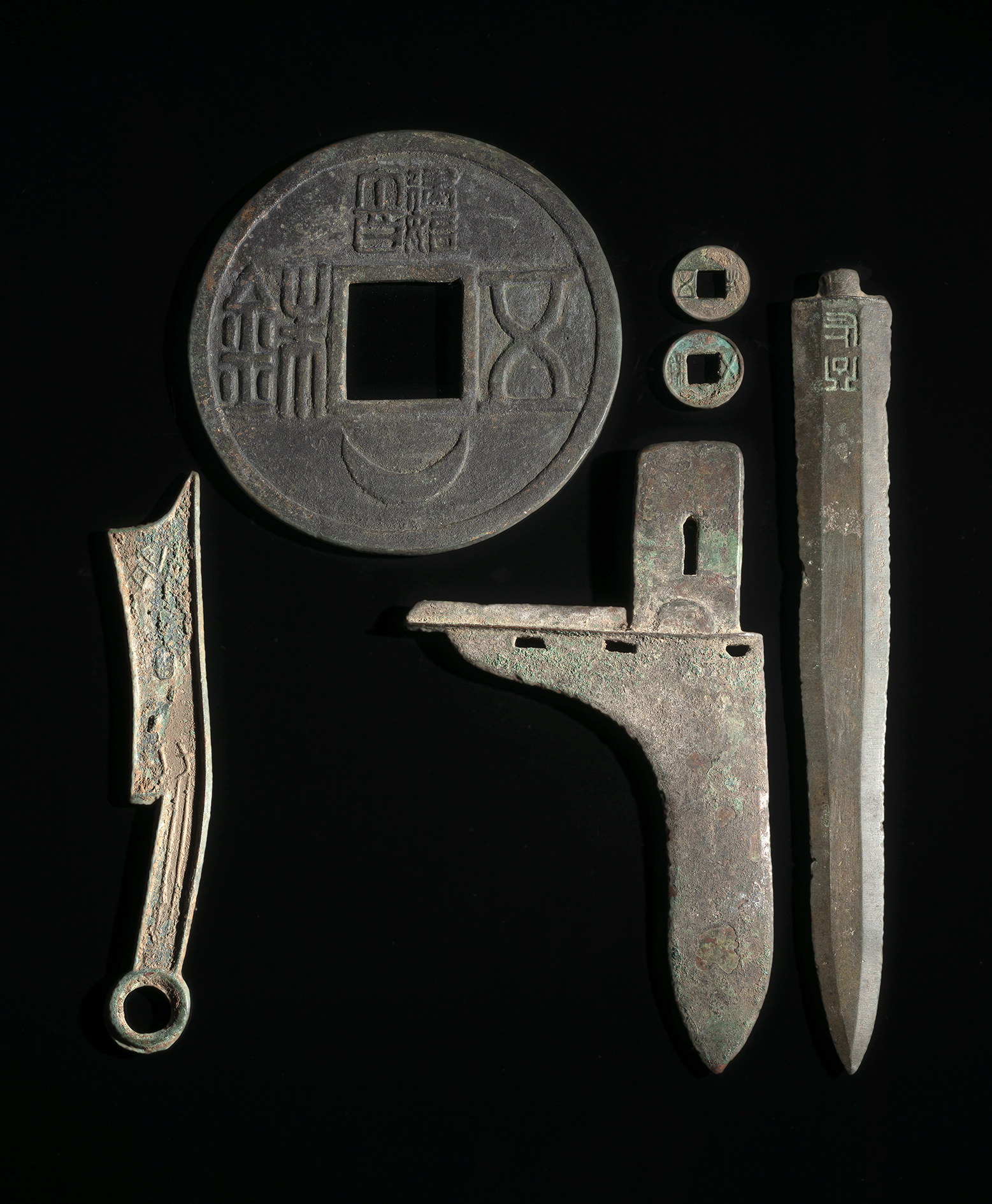 A GROUPE OF COINS AND WEAPONS