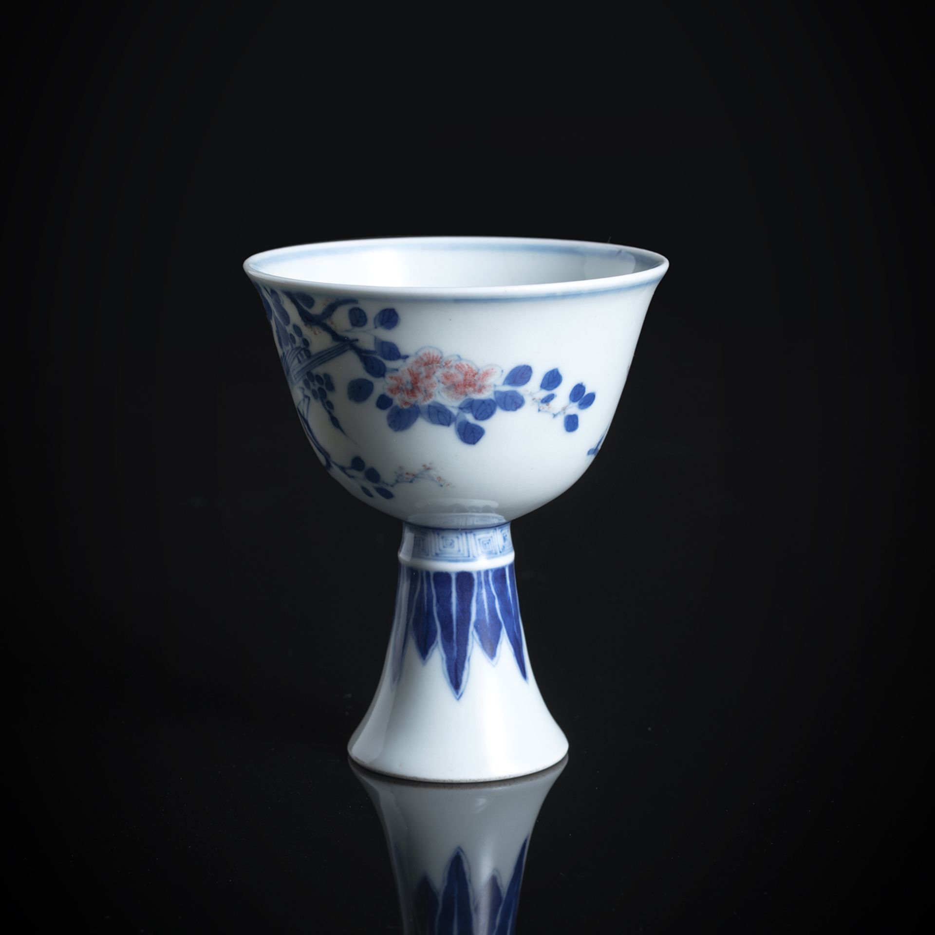 A BLUE AND WHITE AND COPPER-RED DECORATED BIRD AND FLOWER BRANCH STEMCUP