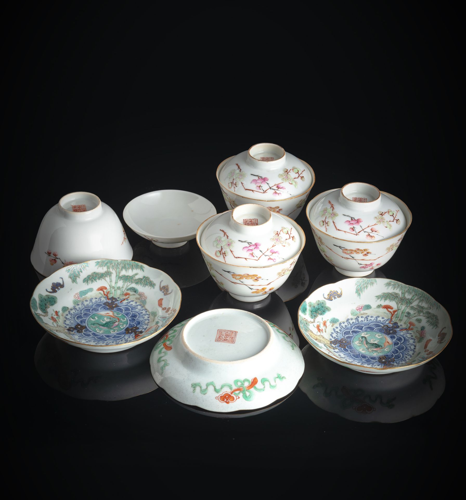 FOUR 'FAMILLE ROSE' TEA BOWLS AND COVERS WITH PRUNUS DECORATION AND THREE SAUCERS DEPICTING LIUHAI