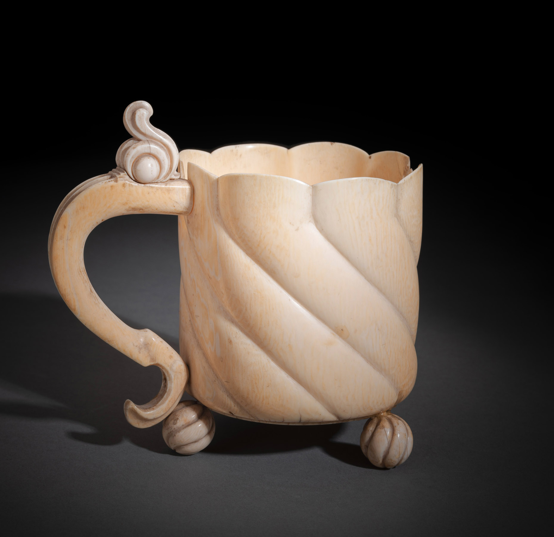A SOUTH GERMAN CARVED IVORY TANKARD