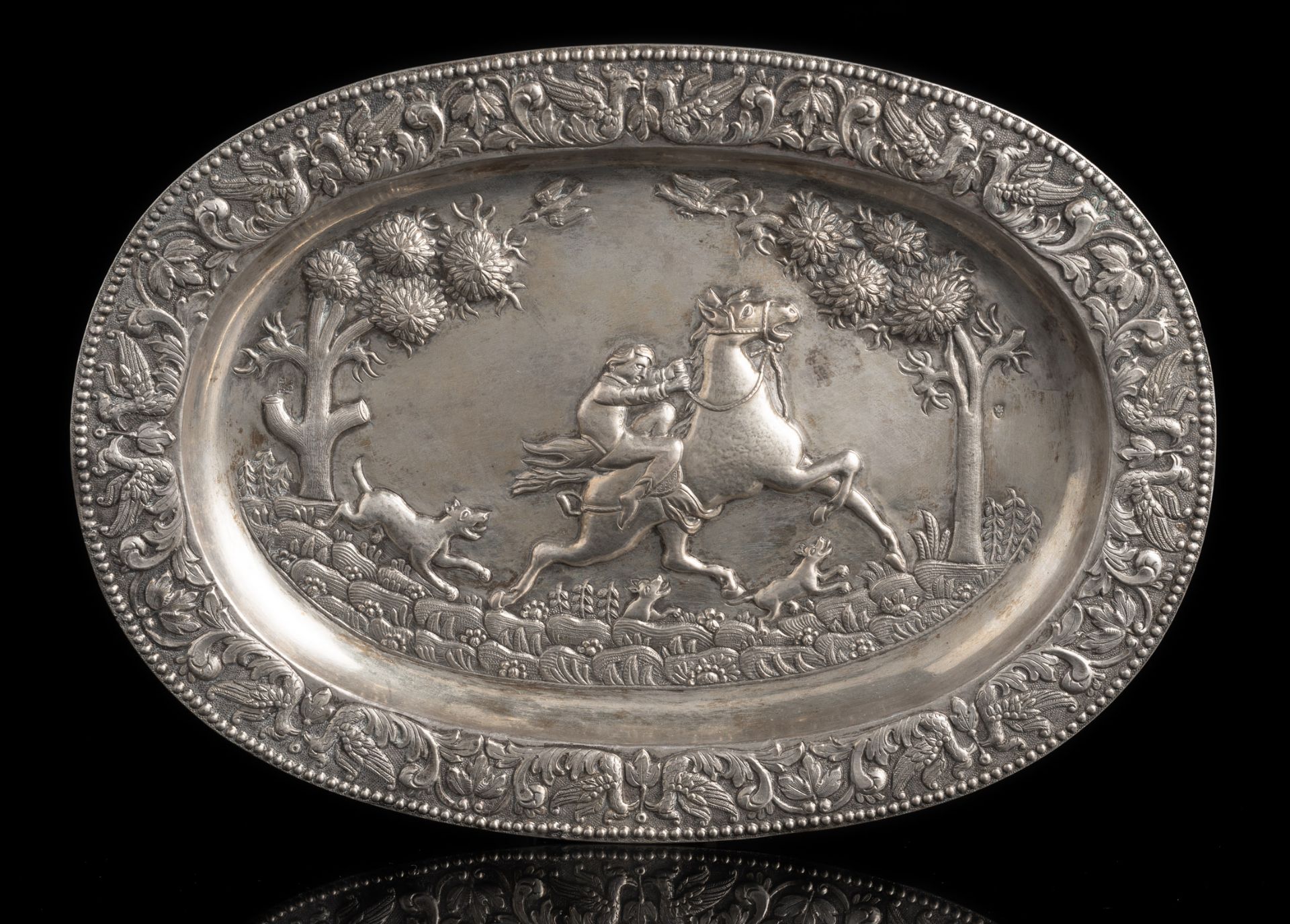 AN OVAL DISH WITH HUNTING SCENE