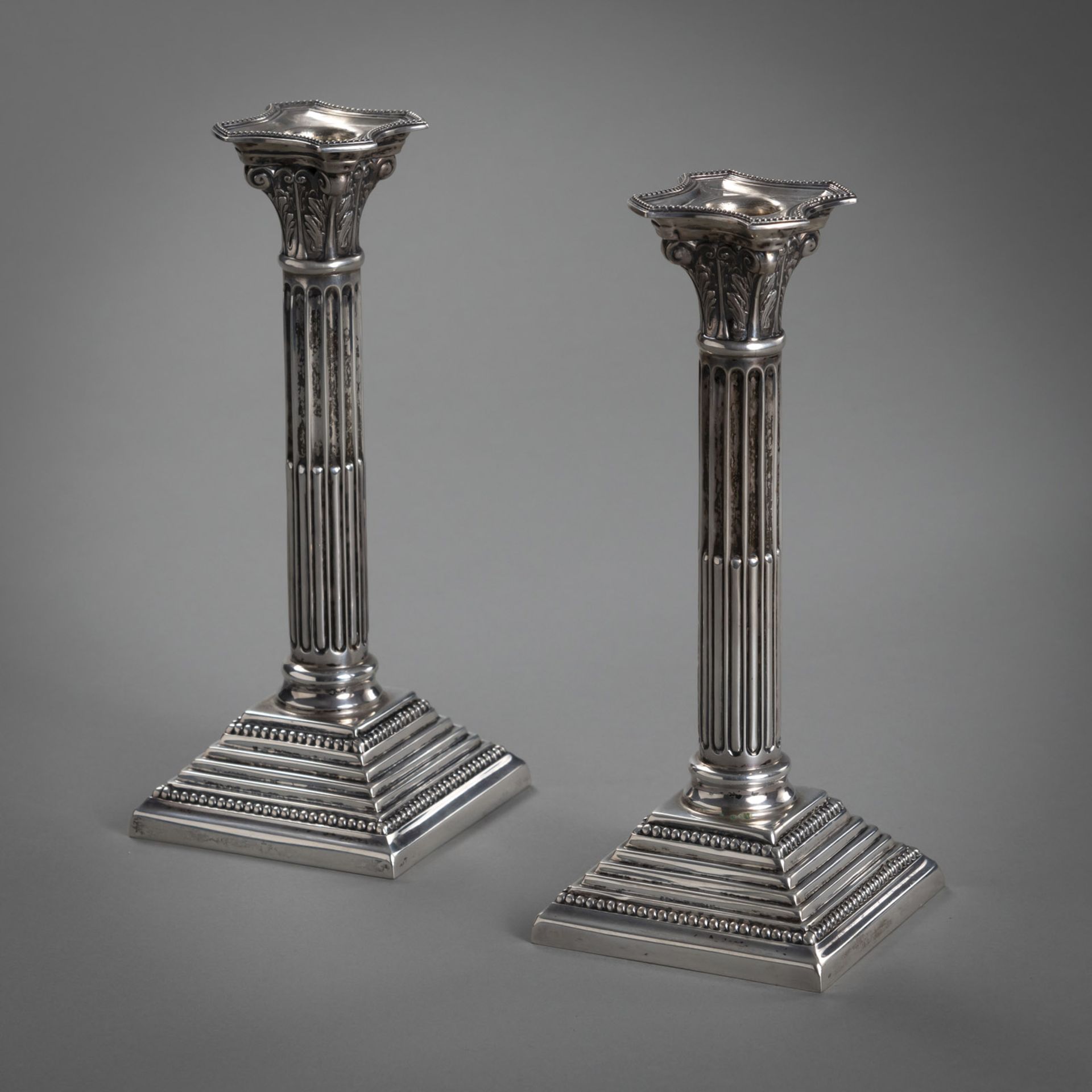 A PAIR OF PORTOGUESE SILVER CANDLESTICKS