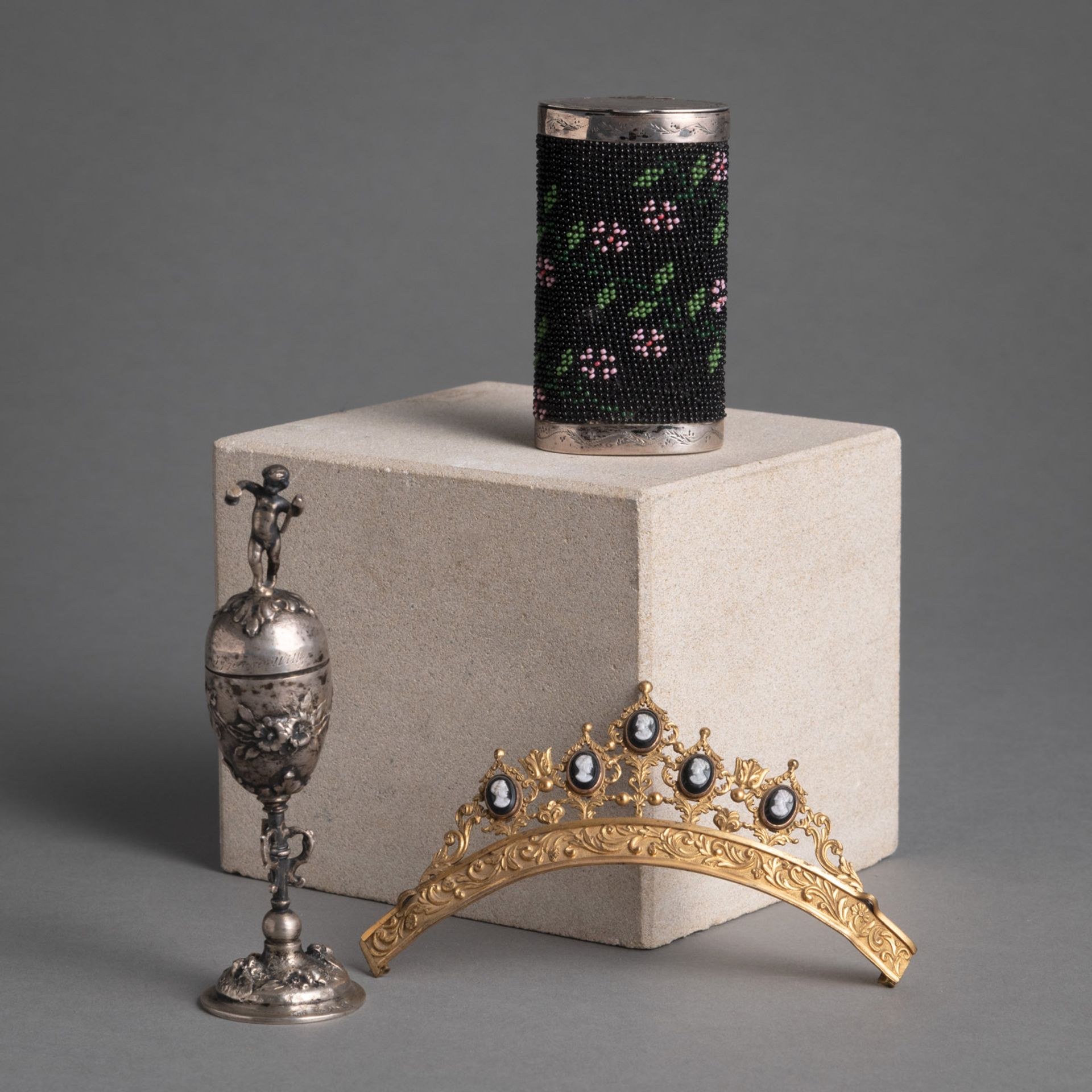 A TIARA, A MINIATURE CUP AND A SMALL CASE