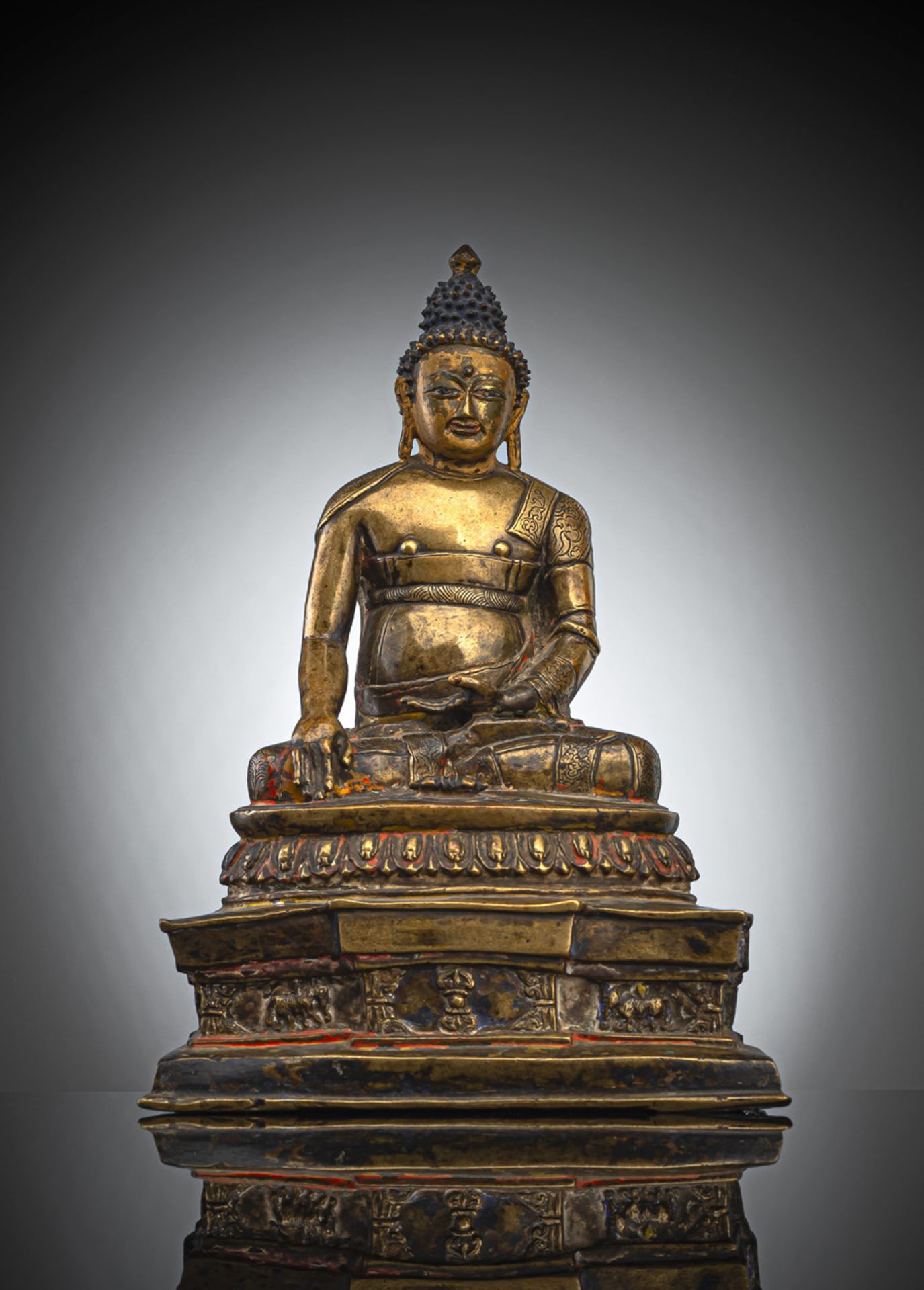 A RARE SILVER-INLAID BRONZE FIGURE OF AKSHOBHYA