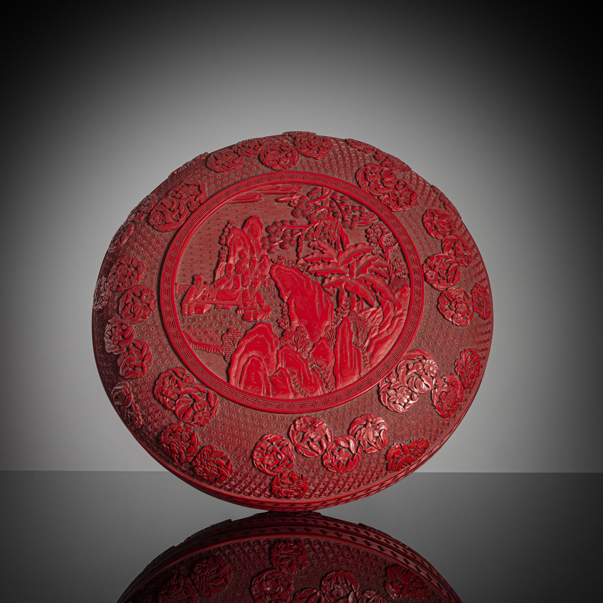A LARGE AND WELL CARVED CINNABAR LACQUER BOX AND COVER WITH SCHOLAR'S