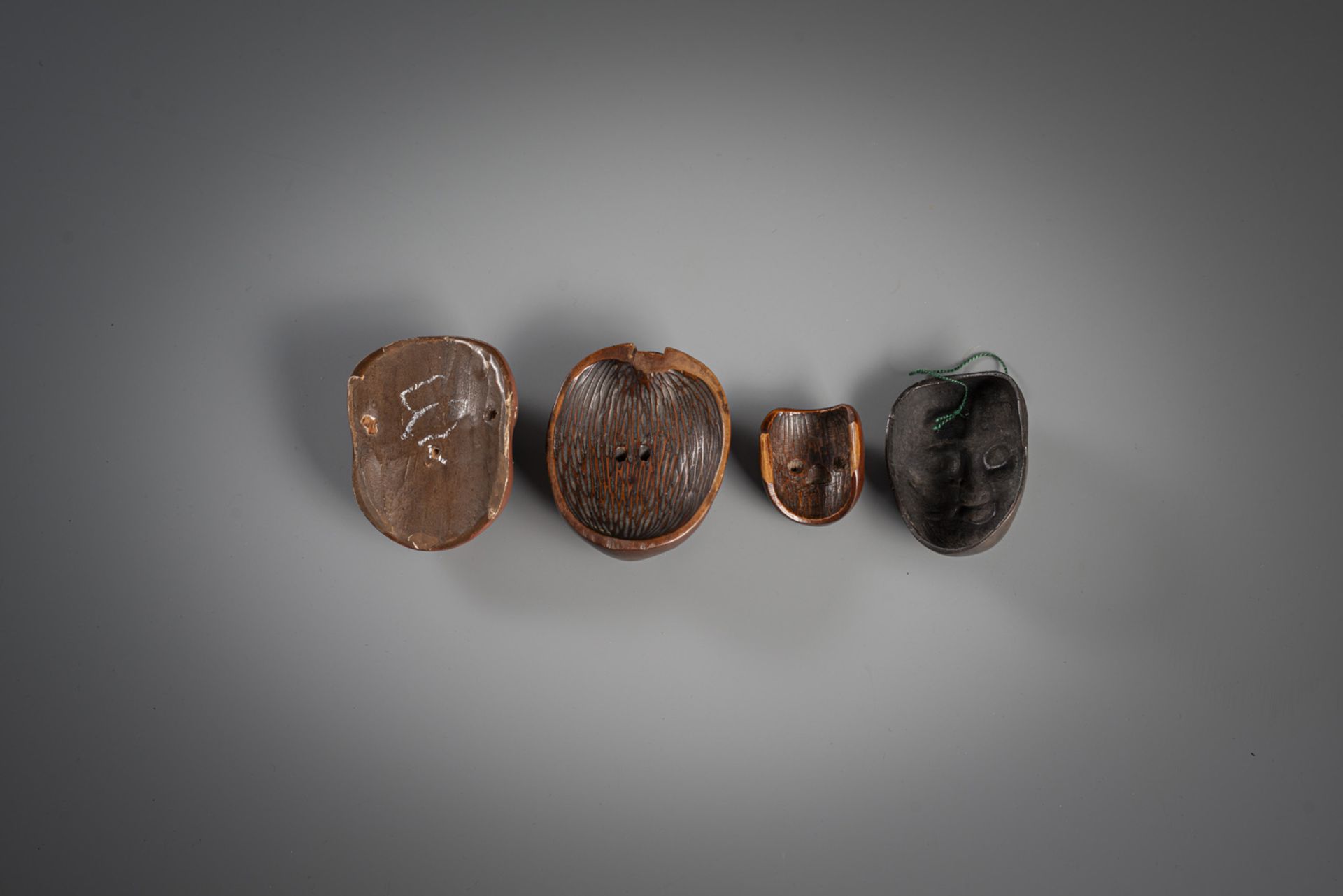 FOUR SMALL MASKS AMONG OTHERS TWO NETSUKE MADE OF WOOD, BRONZE AND CERAMIC - Image 2 of 2