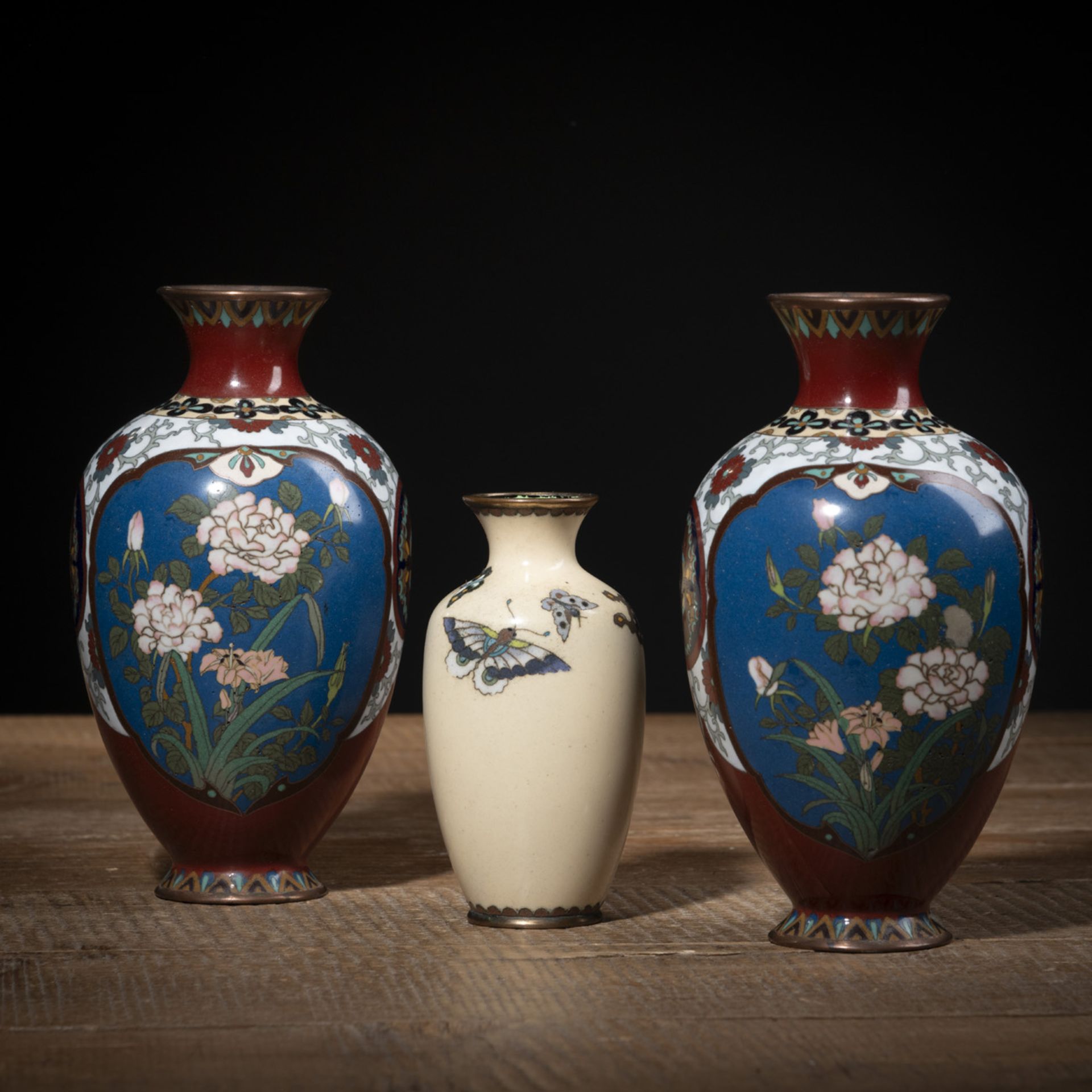 A PAIR OF FLORAL CLOISONNÉ-ENAMEL VASES AND A SMALLER VASE WITH BUTTERFLIES