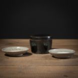 A BLACK-GLAZED BOX AND COVER AND TWO CELADON BOWLS