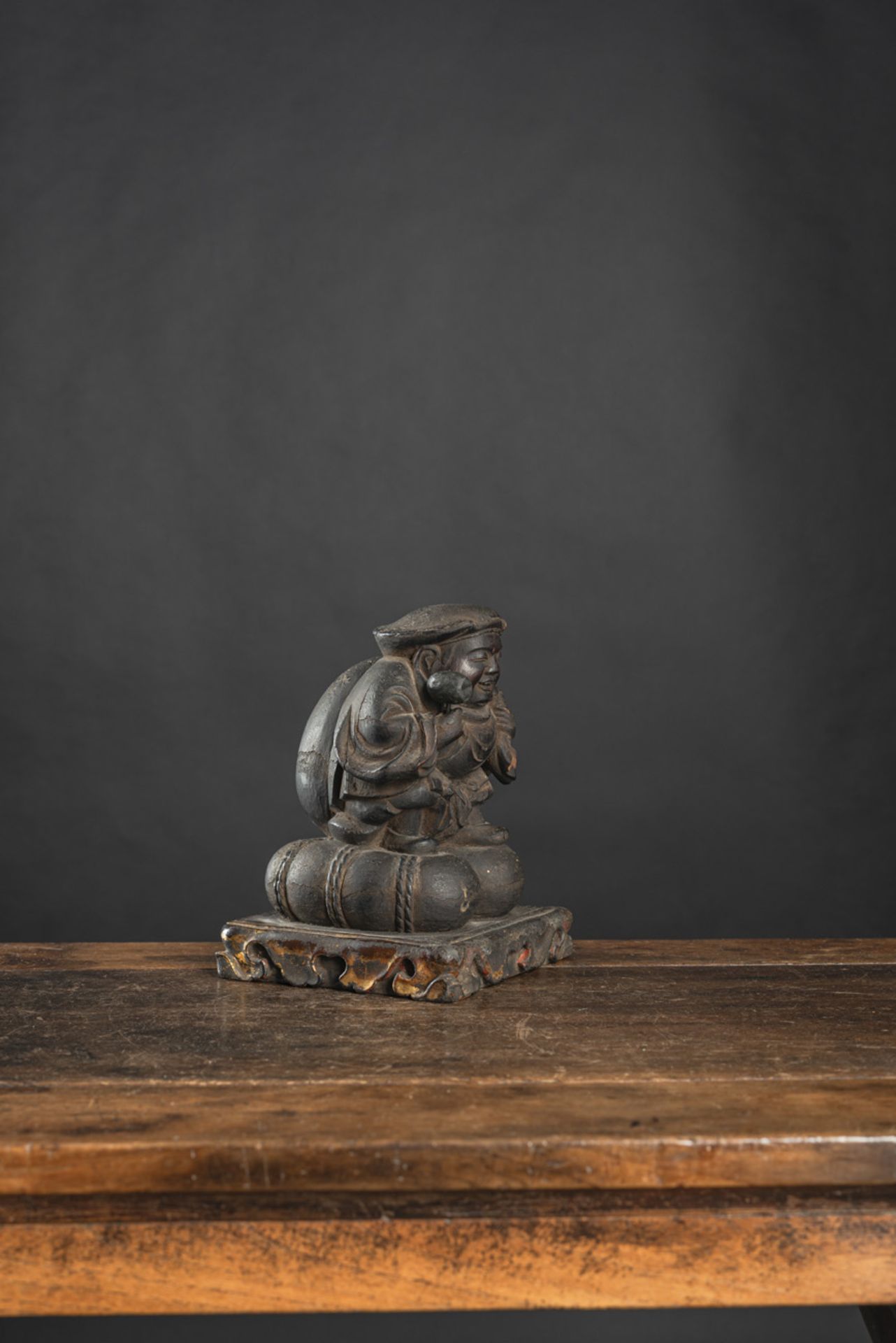 A BLACK-LACQUERED WOOD FIGURE OF DAIKOKU - Image 2 of 4
