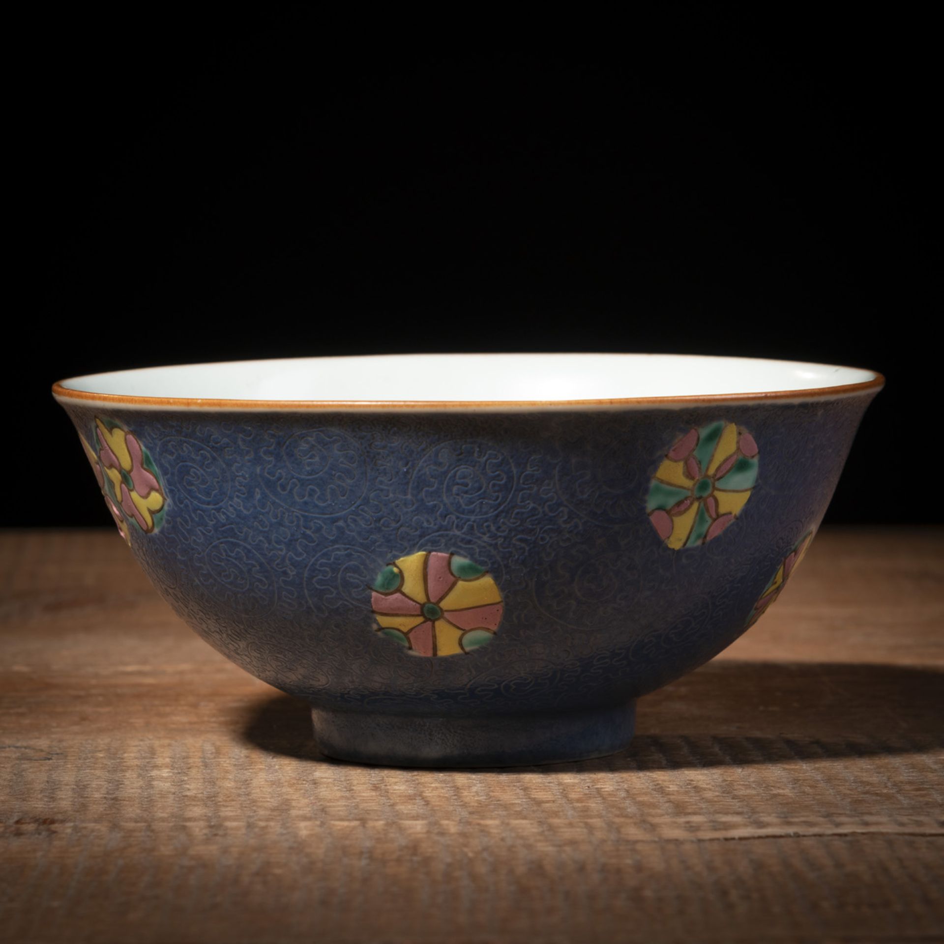 A BLUE-GROUND CARVED PORCELAIN BOWL