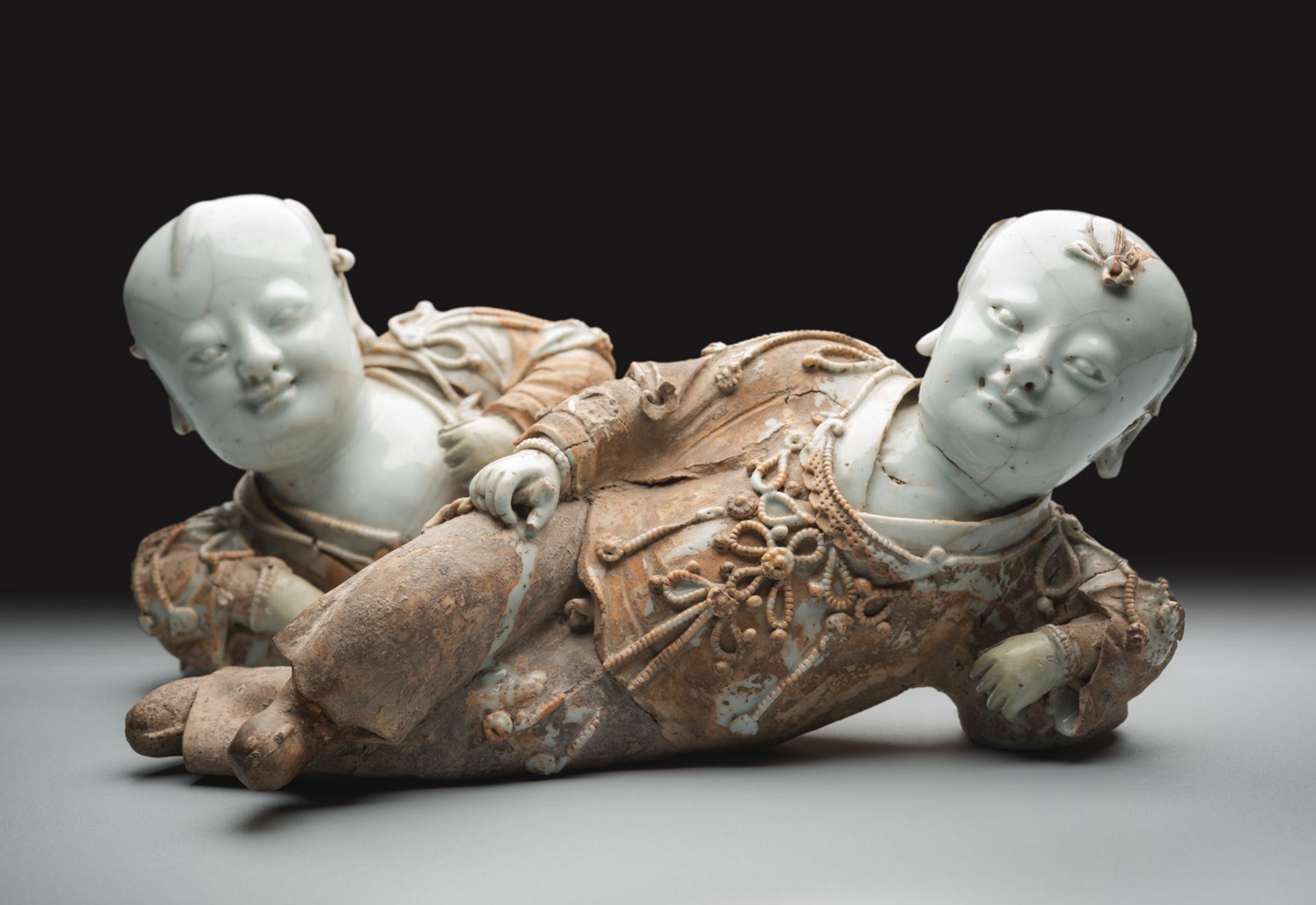 A VERY RARE PAIR OF PART-GLAZED QINGBAI MODELS OF RECLINING BOYS - Image 4 of 6