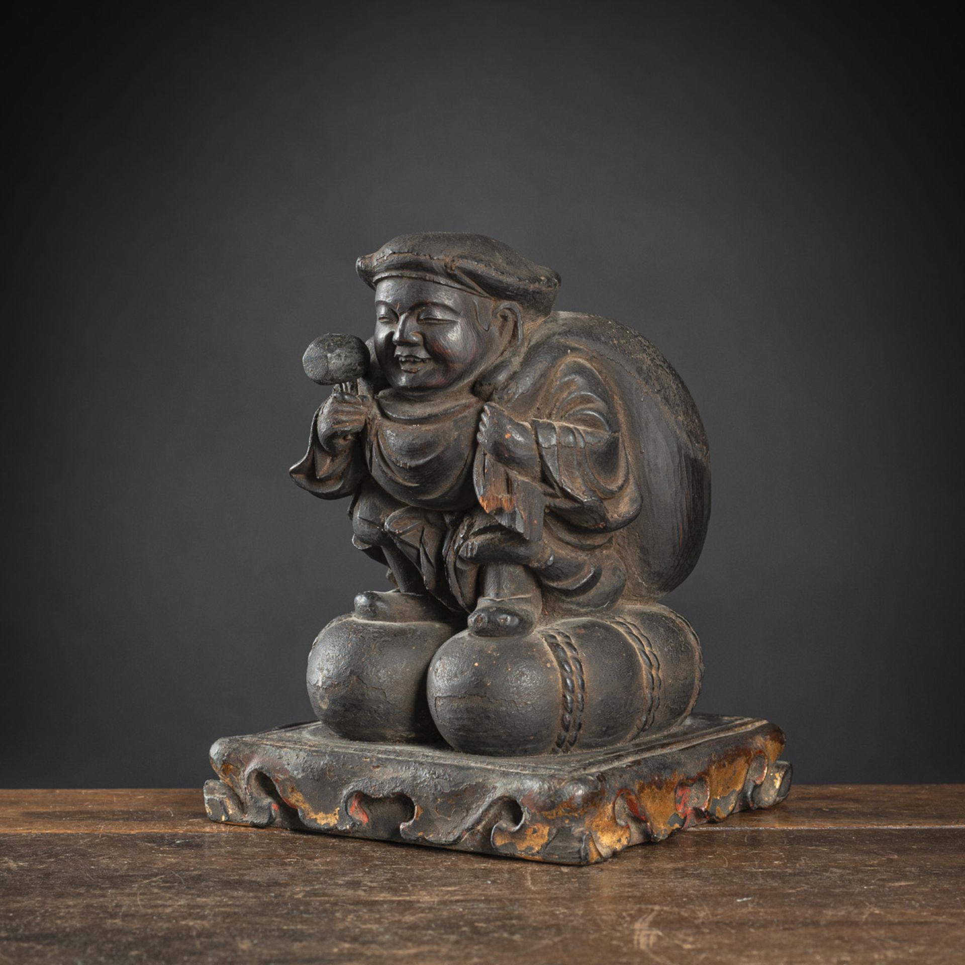 A BLACK-LACQUERED WOOD FIGURE OF DAIKOKU