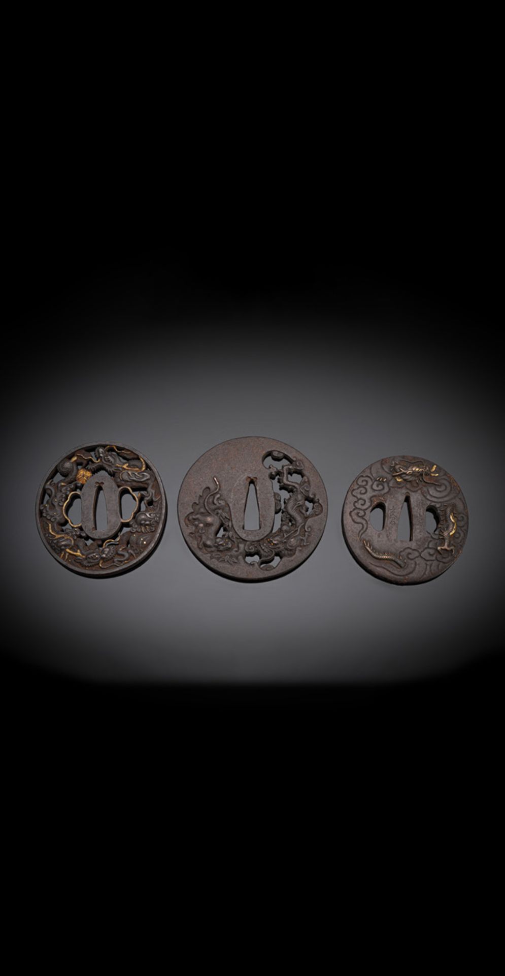 A GROUP OF THREE TSUBA WITH DRAGON DECORATIONS