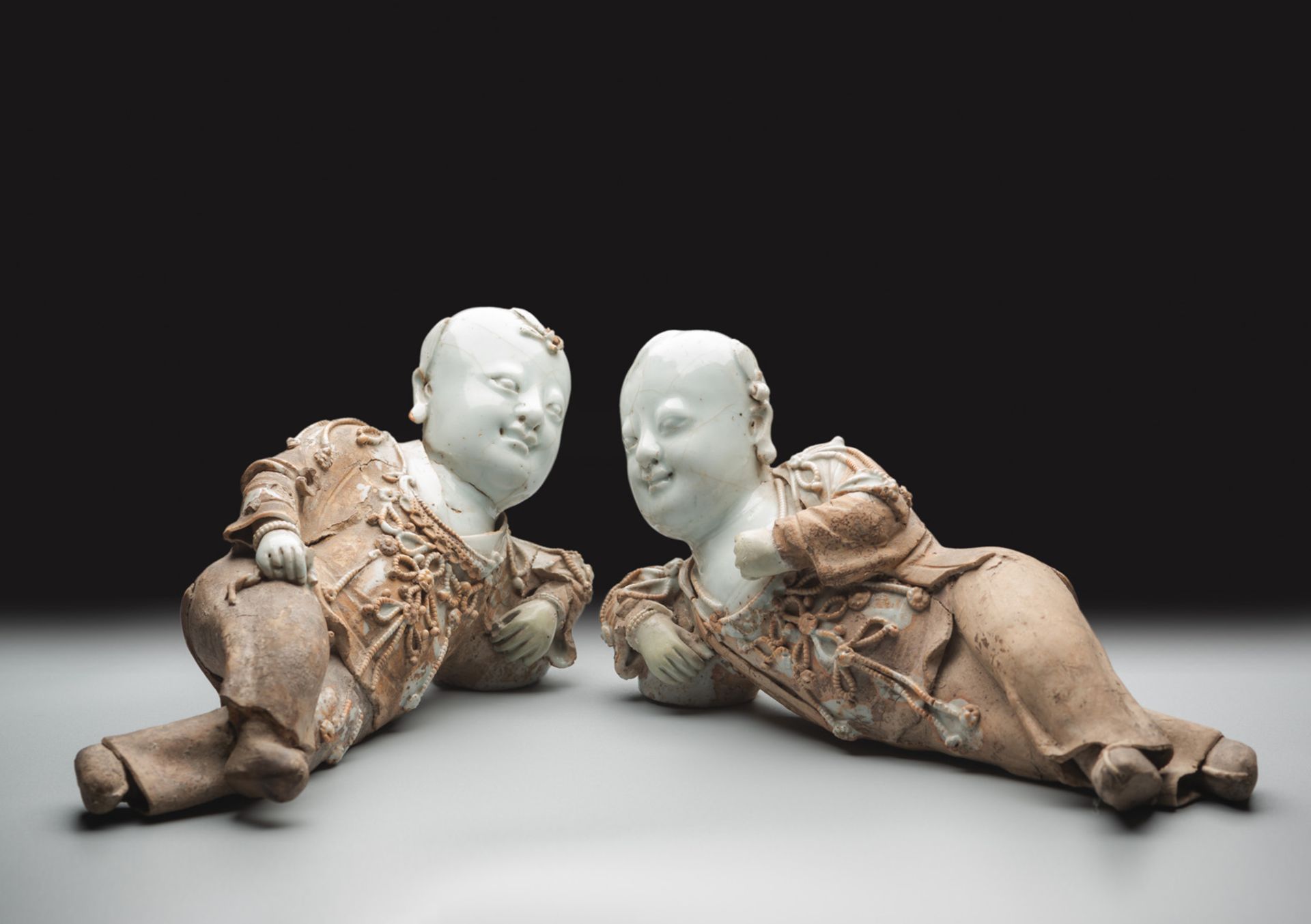A VERY RARE PAIR OF PART-GLAZED QINGBAI MODELS OF RECLINING BOYS - Image 2 of 6