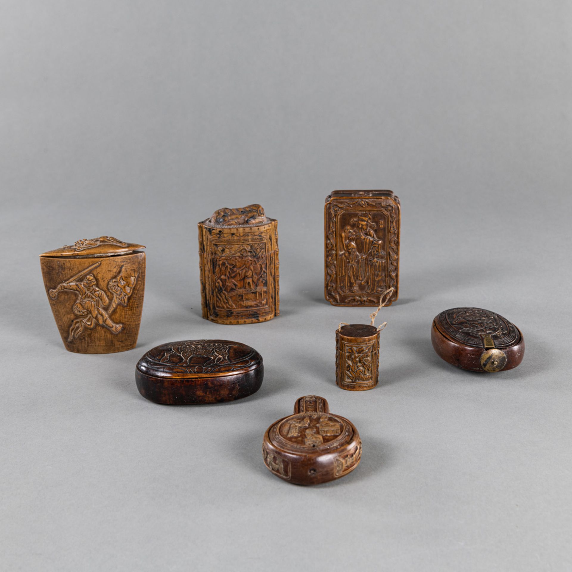 A GROUP OF SEVEN CARVED RELIEF WOOD OPIUM BOXES