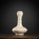 A CREME-GLAZED 'CHILONG' RELIEF BOTTLE VASE