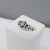 Silver ring set with an oval light blue cubic zirconia and celtic patterned shoulders