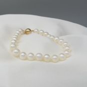 White cultured pearl strung bracelet with yellow gold ball clasp