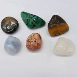 Six large natural tumbled gemstones including tiger's eye, jasper and onyx. 335.0 carats total