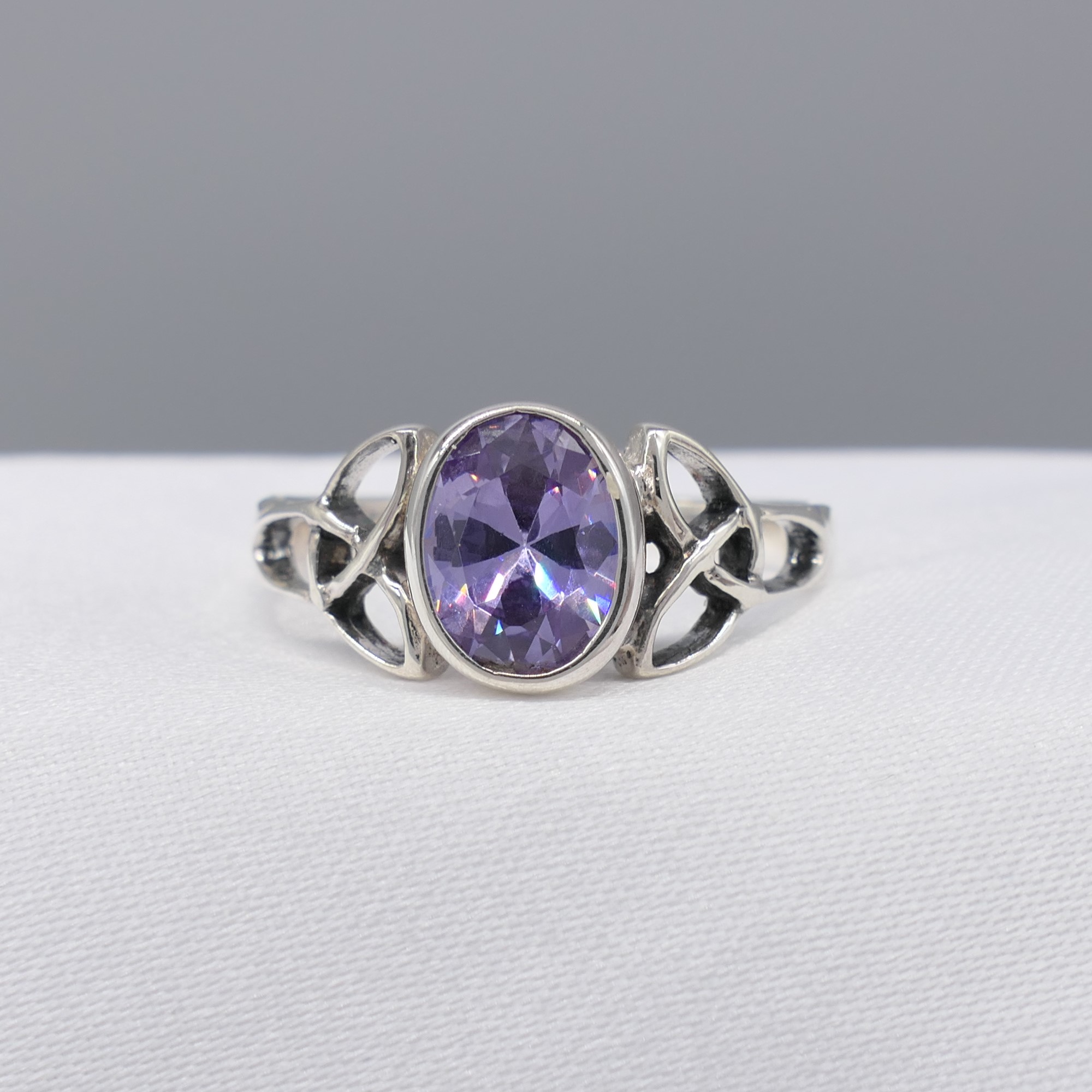 Sterling silver Celtic-style dress ring set with an oval purple cubic zirconia