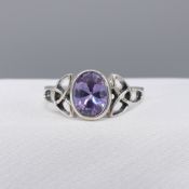 Sterling silver Celtic-style dress ring set with an oval purple cubic zirconia