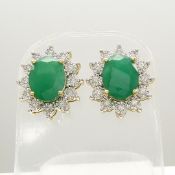 Emerald and diamond oval cluster earrings with butterfly backs, in yellow gold