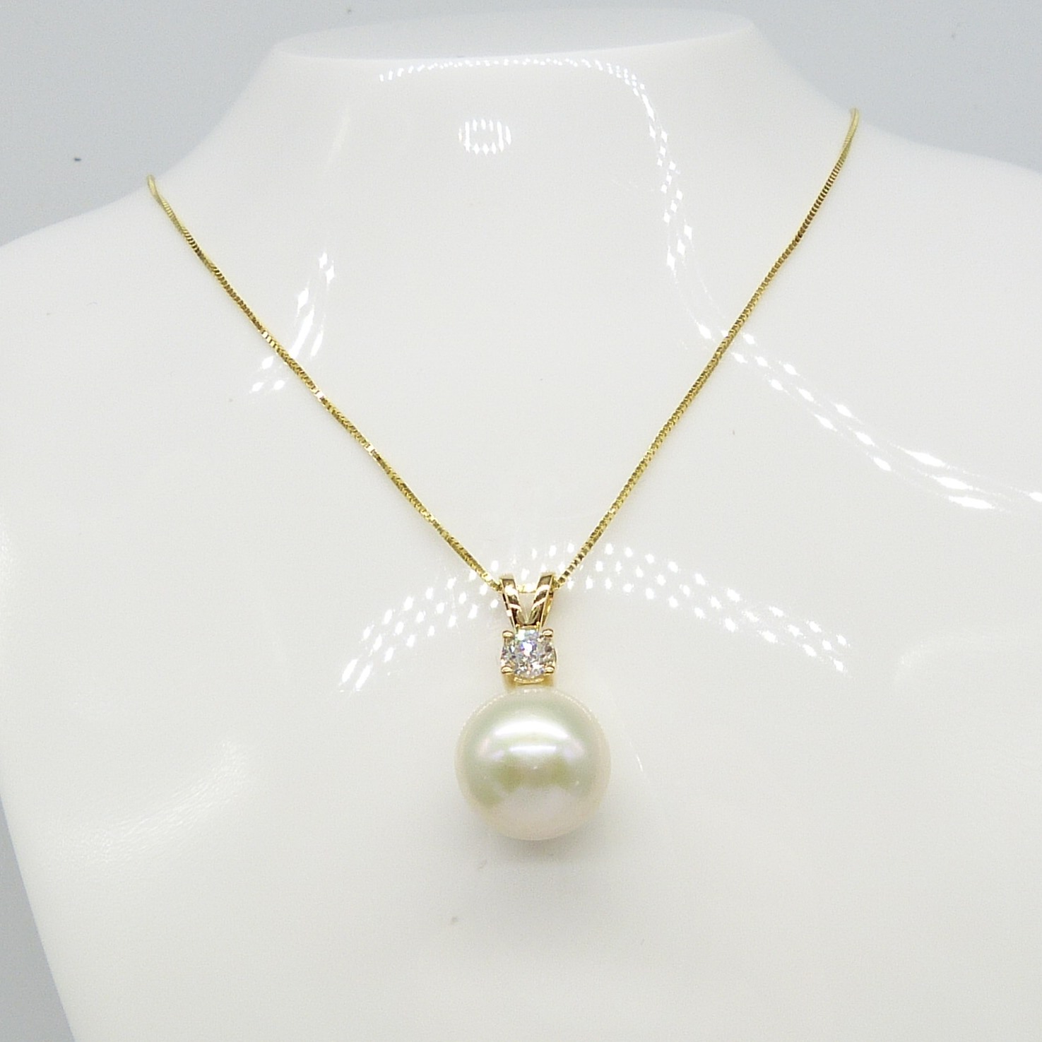 Yellow gold round freshwater pearl and 0.23 carat diamond necklace