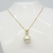 Yellow gold round freshwater pearl and 0.23 carat diamond necklace