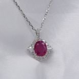 Certificated 18ct white gold oval ruby and diamond cluster pendant and chain, certificated