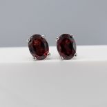 Pair of deep red garnet sterling silver ear studs with butterfly backs