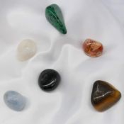 Six large natural tumbled gemstones including tiger's eye, jasper and onyx. 335.0 carats total.