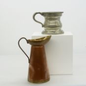 A vintage pewter drinking vessel with a brass and copper jug