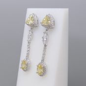 Pair of silver droplet stone-set articulated regency-style earrings.