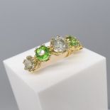 18ct yellow gold twin-prong-set graduated diamond and green stone ring.