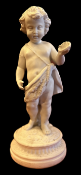 A parianware figure of a cherub standing draped in a skin and holding out a scallop shell.