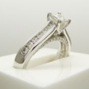 0.98 carat diamond solitaire ring with diamond shoulders and bridge, in 14ct white gold.