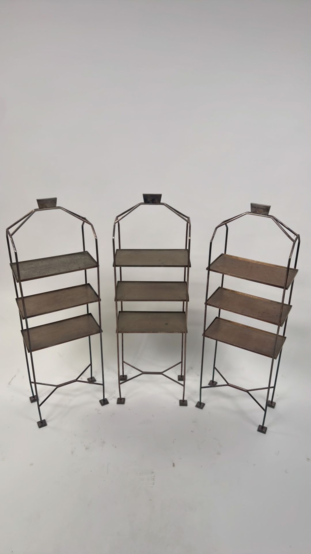 A trio of metal sandwich and cake stands