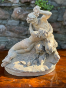 c19th Terracotta Group signed 'Michel Clodian' showing a faun offering grapes to a nymph.