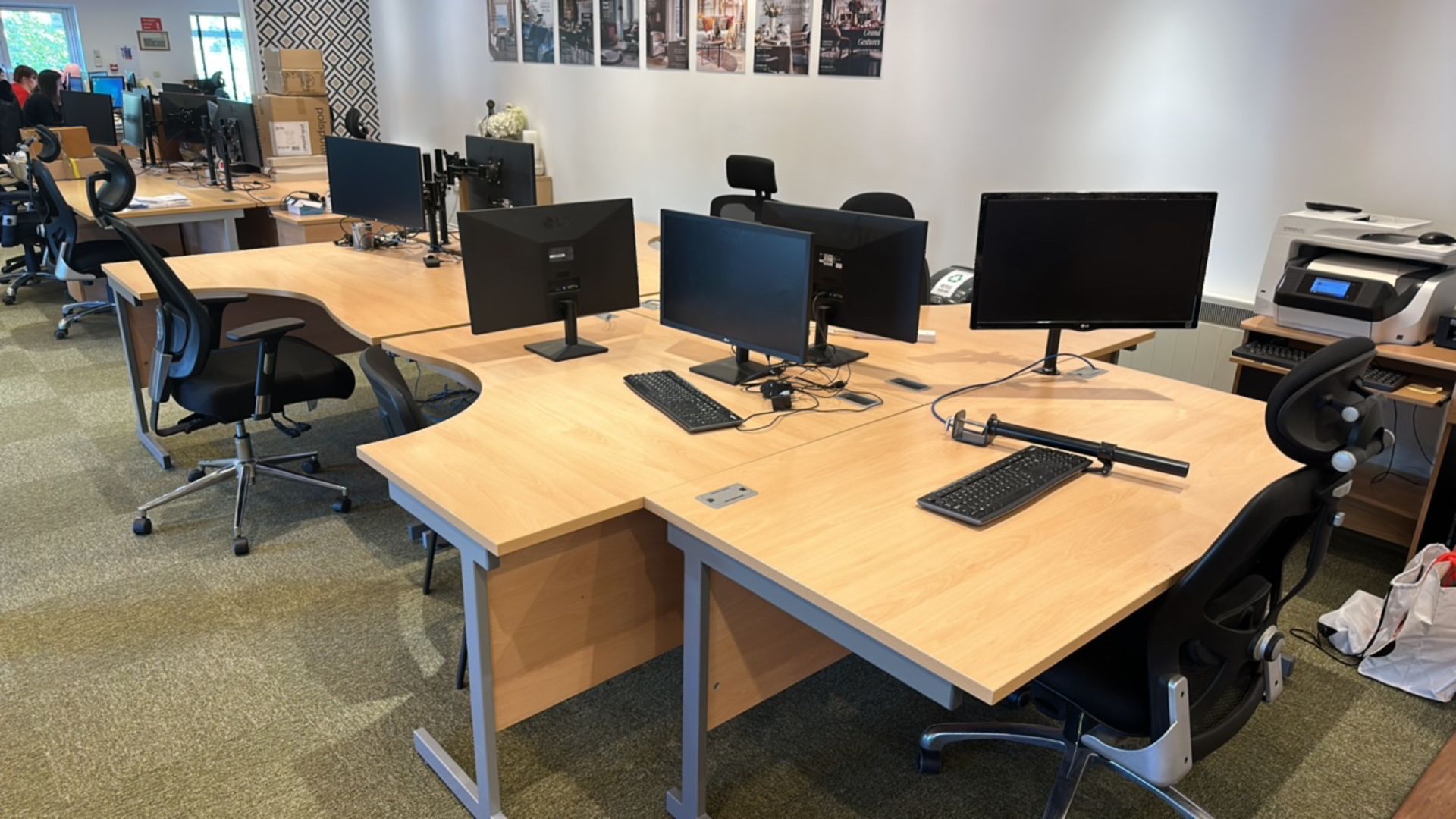 Bank of office desks with monitors and chairs