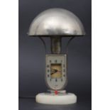 "MOFEM" - Tischlampe mit Uhr, auf getrepptem Rundsockel aus Naturstein montiertes, vernickeltes Met