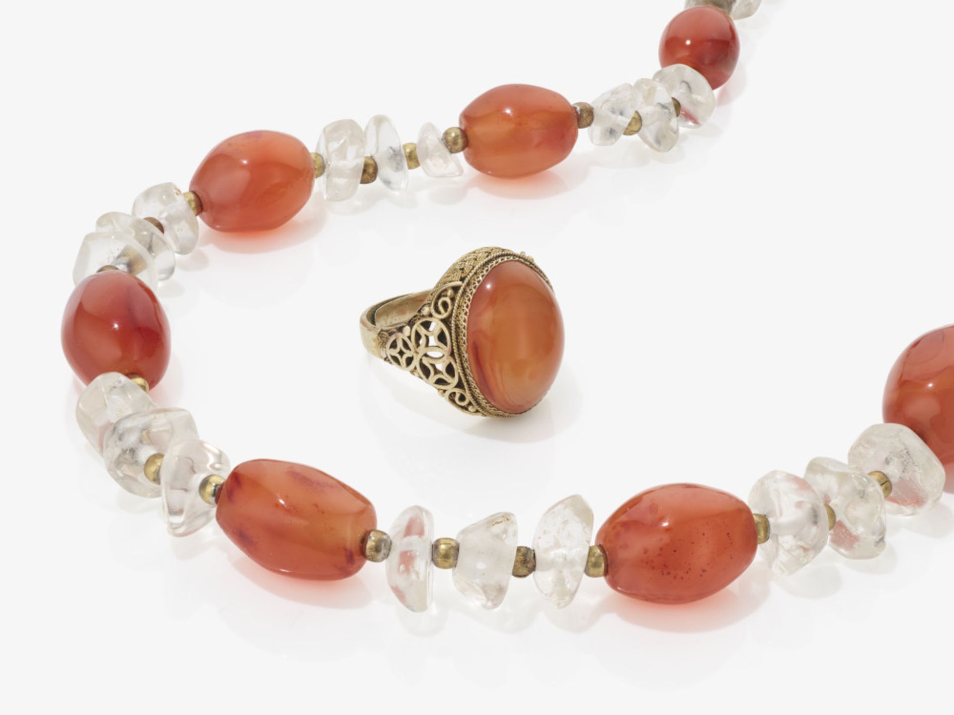 A necklace with rock crystal and carnelian, carnelian ring