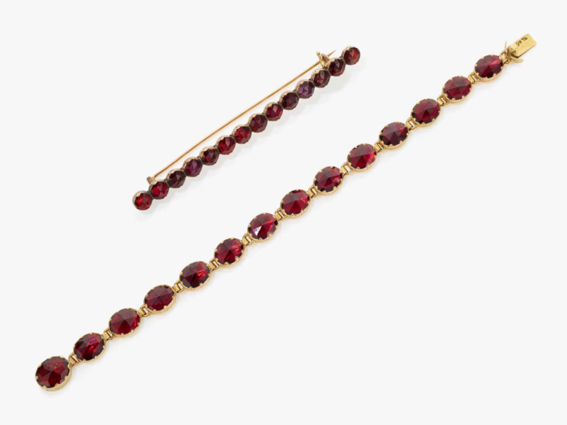 A historical bracelet and bar pin decorated with garnets