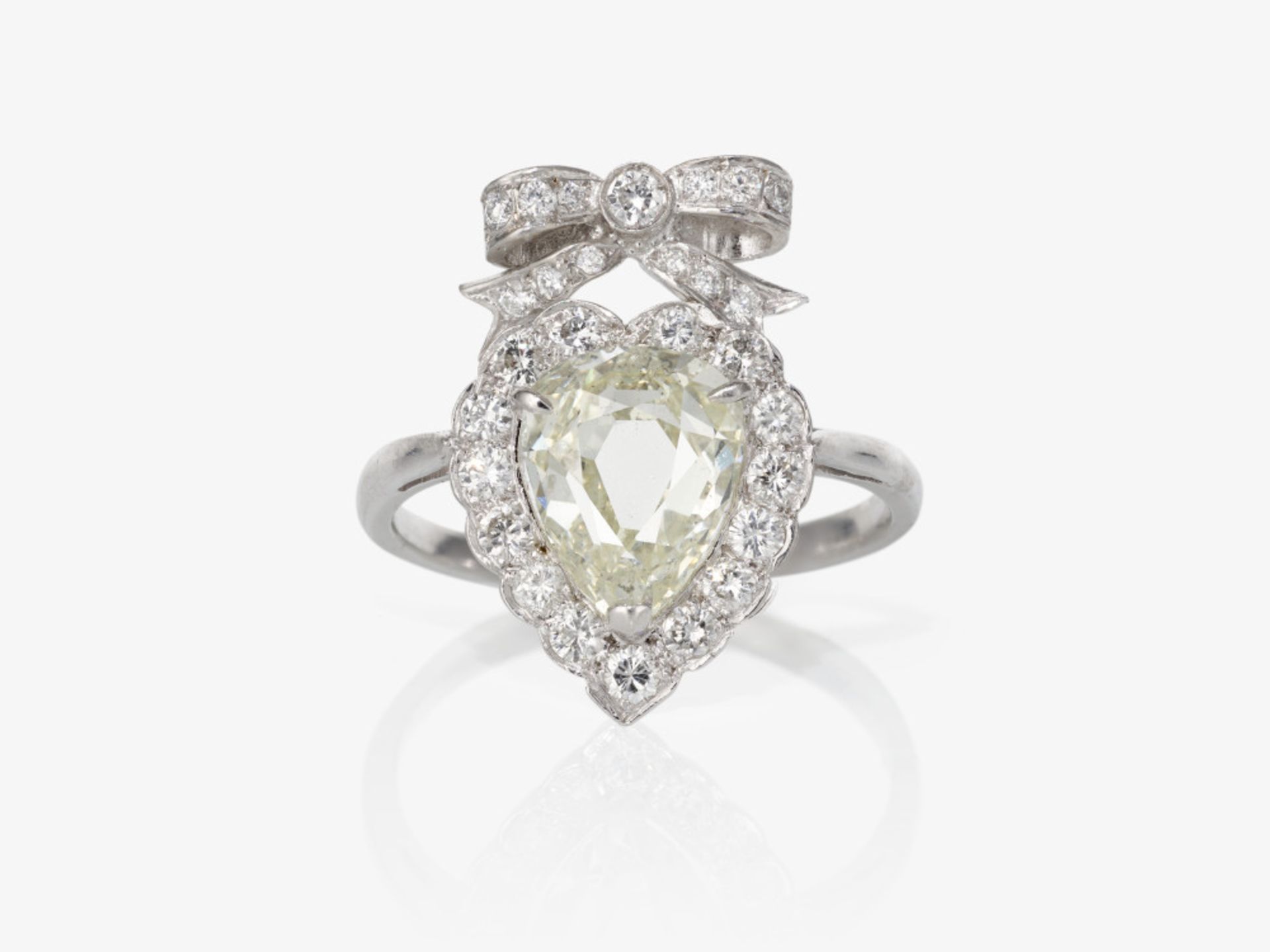 A ring with a pear shaped diamond and brilliant-cut diamonds