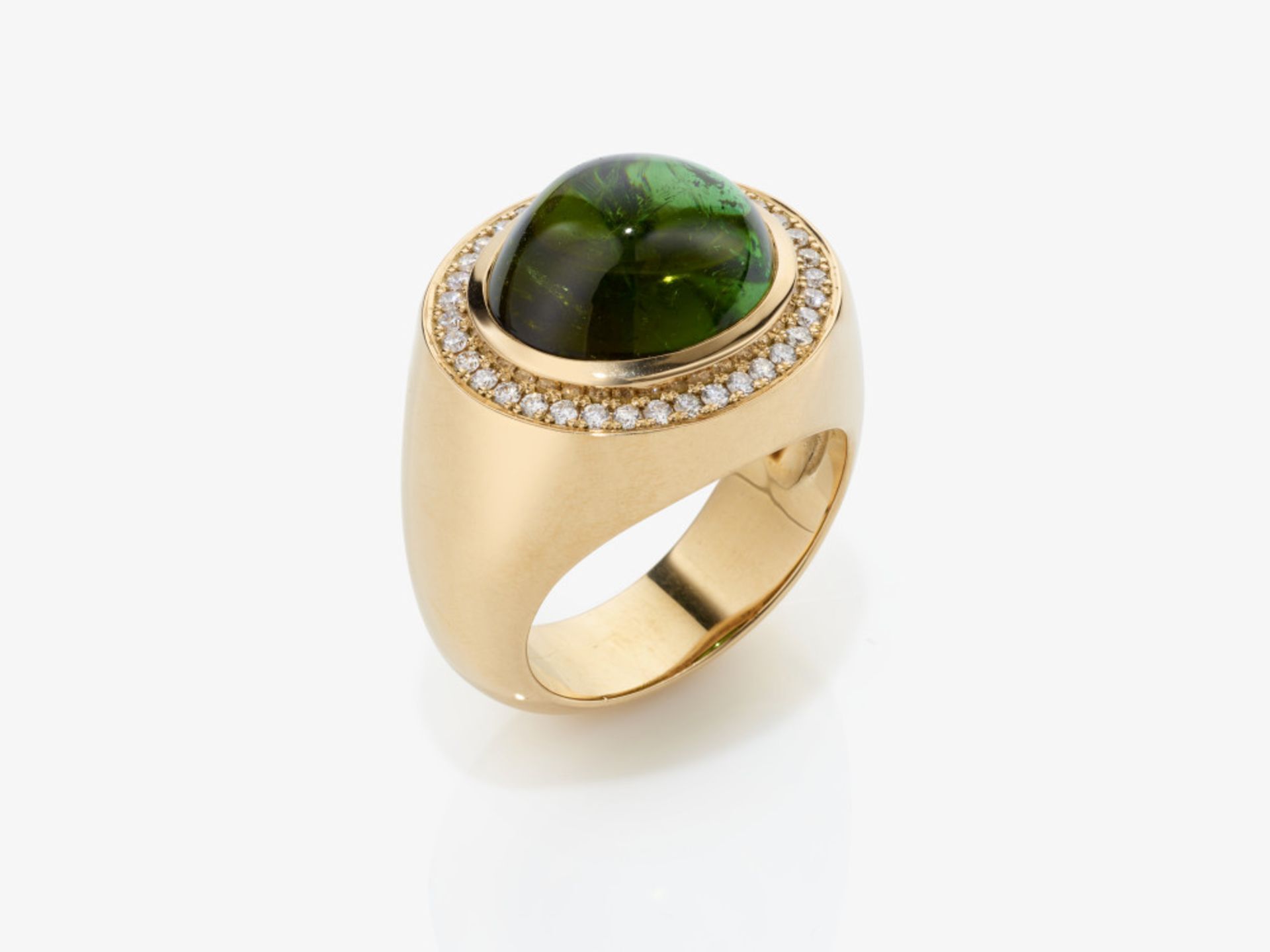 A cocktail ring decorated with a fine green cabochon-cut chrome tourmaline and brilliant-cut diamond