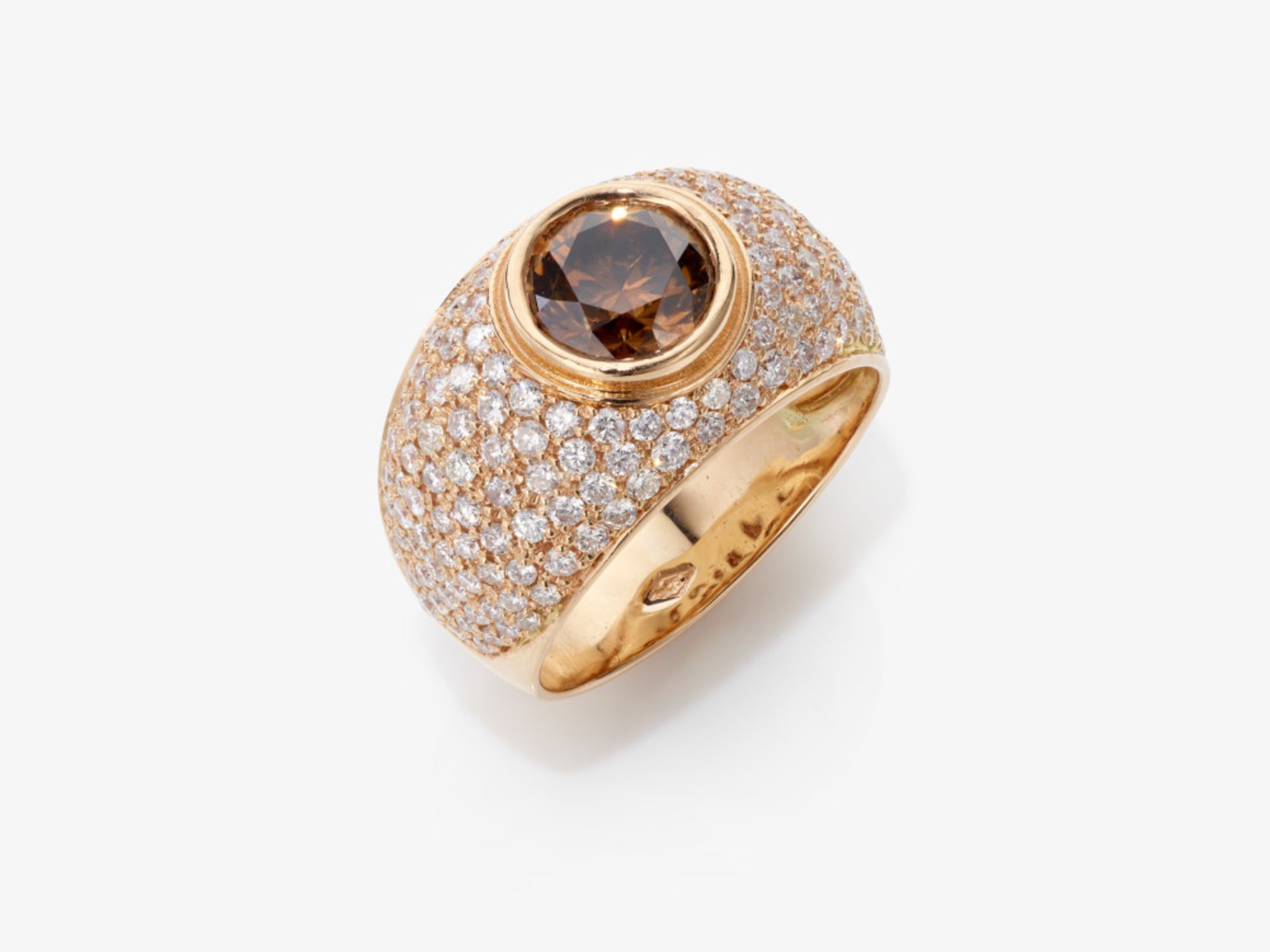 A cocktail ring decorated with a fancy deep orangy brown brilliant-cut diamond and white brilliant-c
