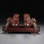 A pair of natural amber lions from the 19th century