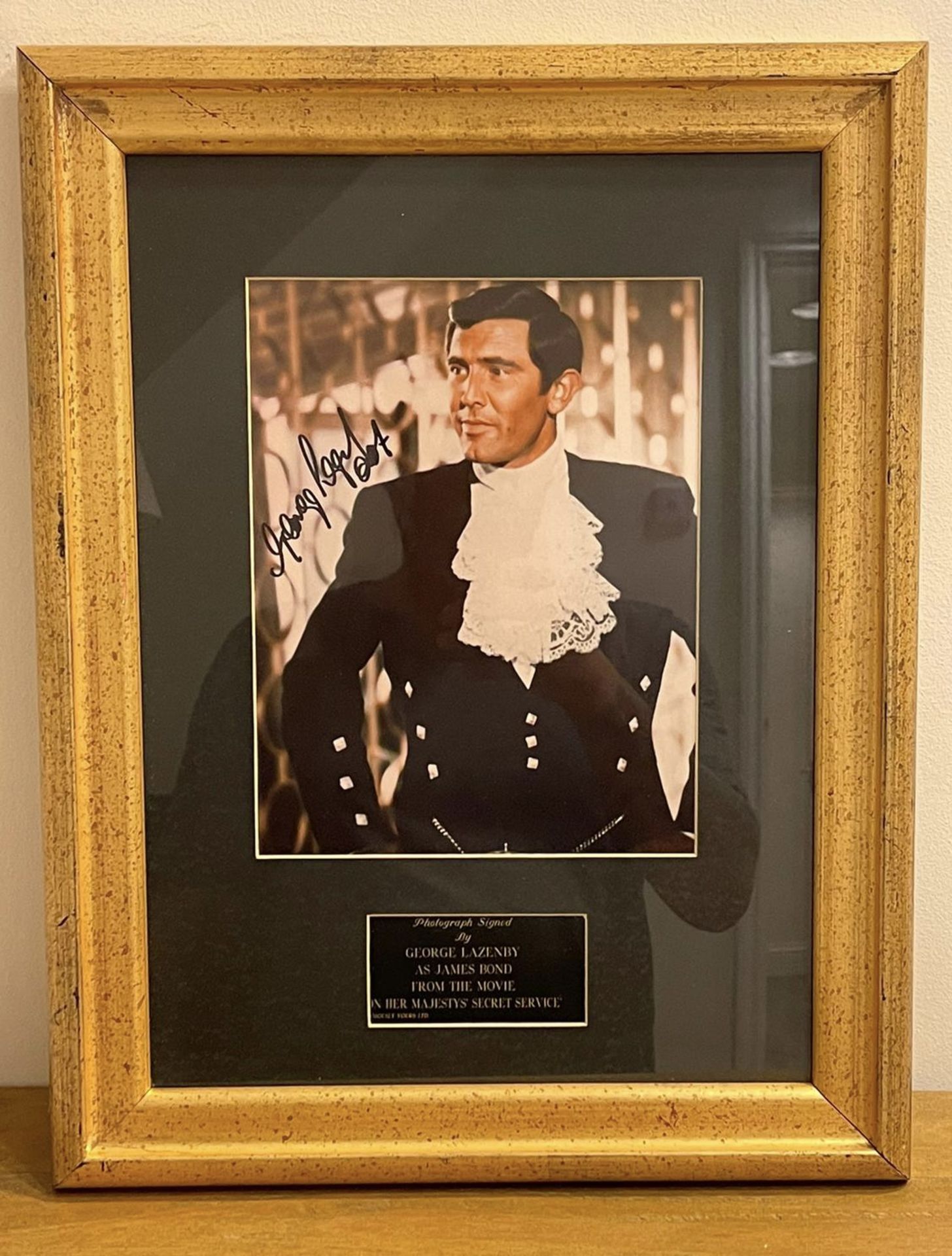 HAND SIGNED framed photograph of 'George Lazenby' as James Bond with COA