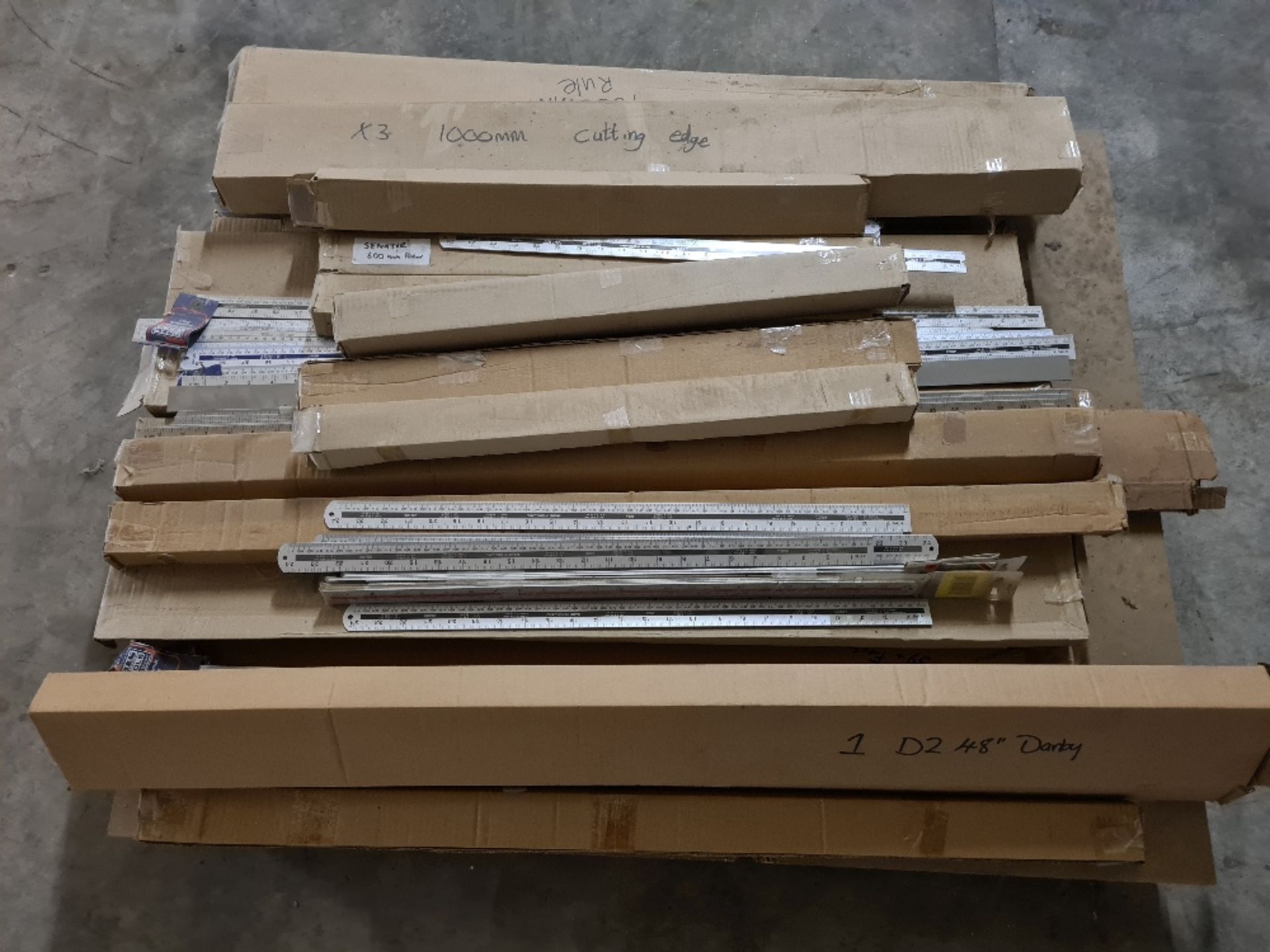 Pallet of new, unused aluminium rulers and cutting edges.