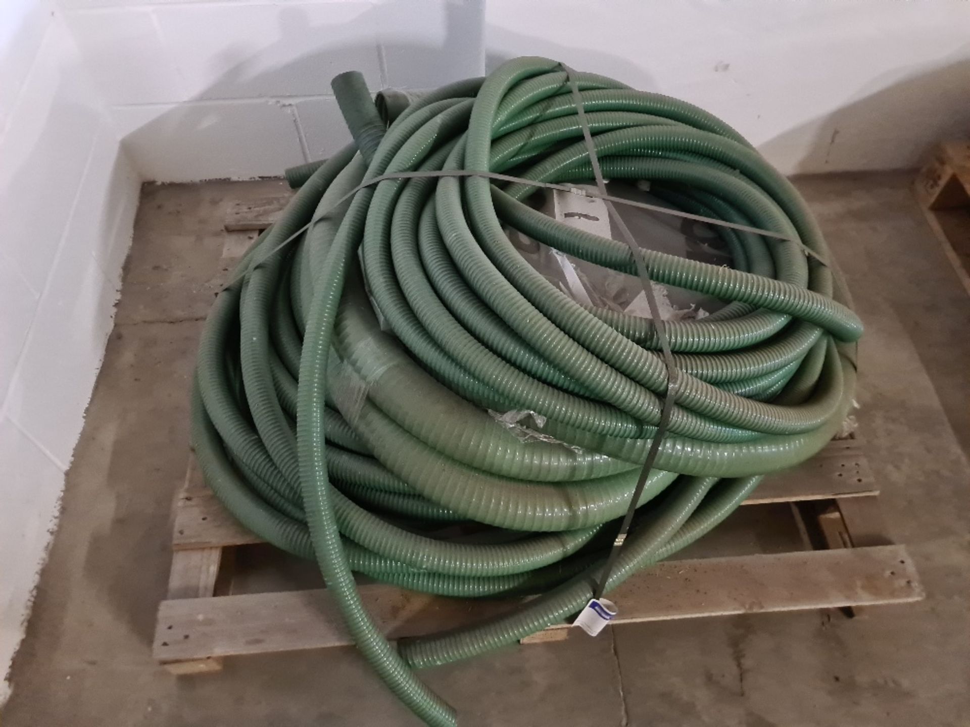 Pallet of green hose.