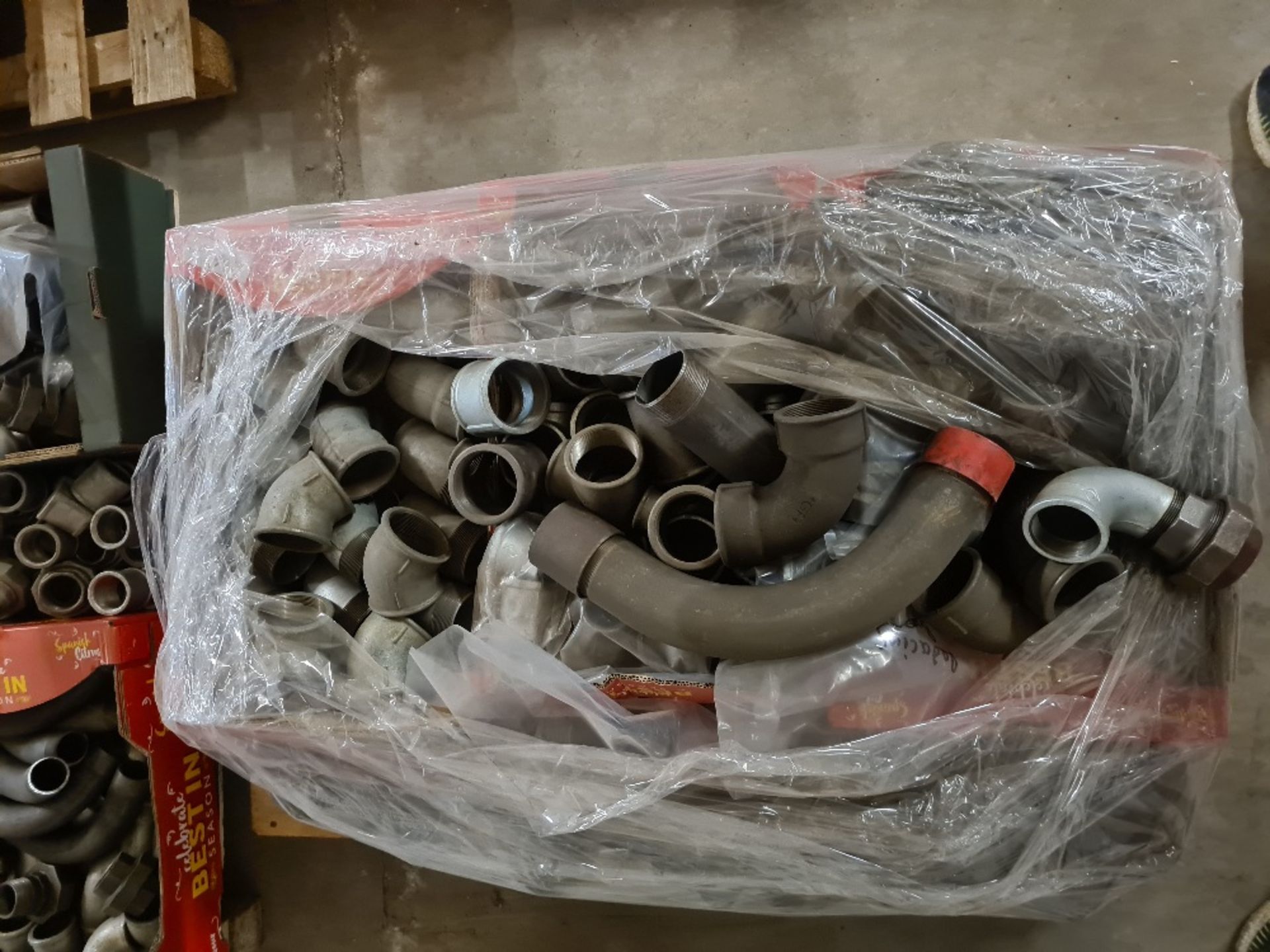 Pallet of 2.5" malleable pipe fittings.